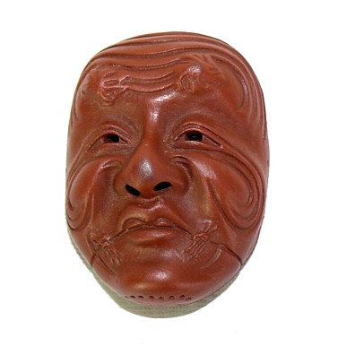 японская нэцкэ в виде маски персонажа театра НО